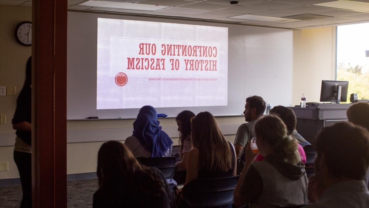 Students watching a presentation on "Confronting our History of Fascism"